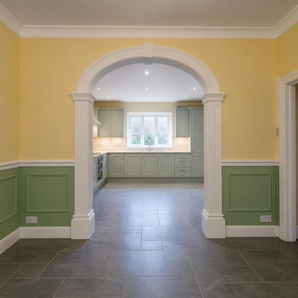 Arched kitchen entrance with fluted pillars